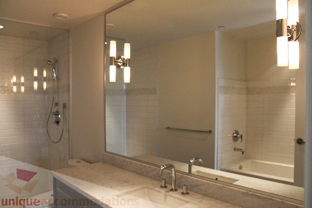 Spacious bathroom with marble countertops and modern lighting fixtures. - 301 - 650 Evergreen Place, North Vancouver