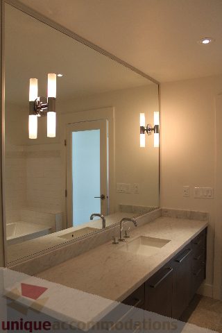 Spacious bathroom with marble countertops and modern lighting fixtures. - 301 - 650 Evergreen Place, North Vancouver