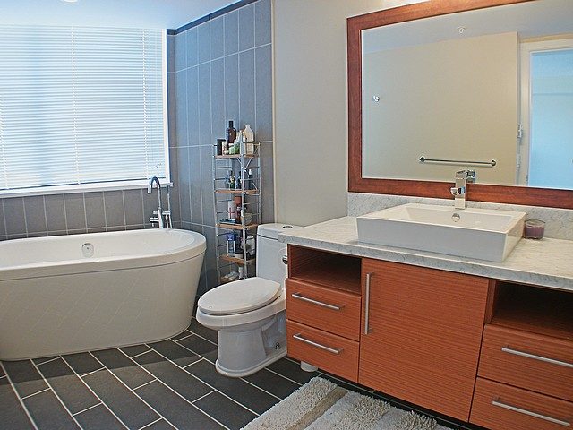 Modern bathroom with dual sink vanity and large mirror, white and gray tile walls. - 3705 - 689 Abbott Street, Vancouver Downtown