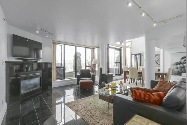 Furnished living room with modern decor, city view, and sleek black countertops. - PH6  2806 - 950 Cambie Street, Vancouver Downtown