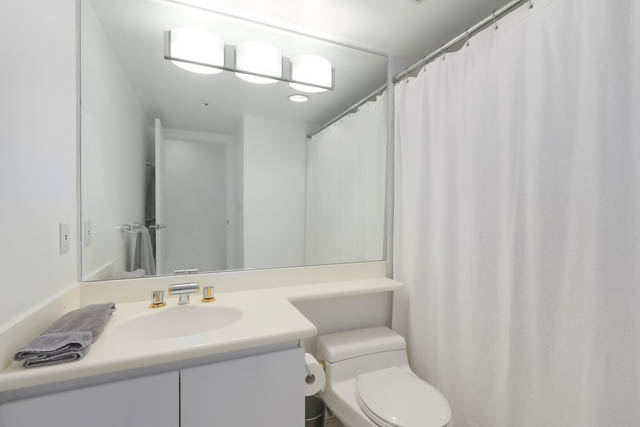 Bright bathroom with white vanity and shower curtain. - PH6  2806 - 950 Cambie Street, Vancouver Downtown