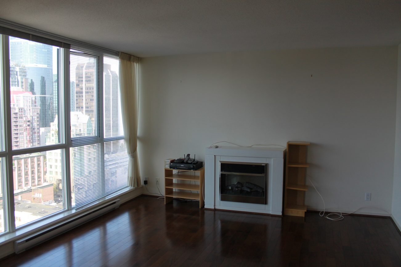 Bright living room with hardwood floors, city view, and modern fireplace. - 2001 - 1199 Seymour, Vancouver Downtown