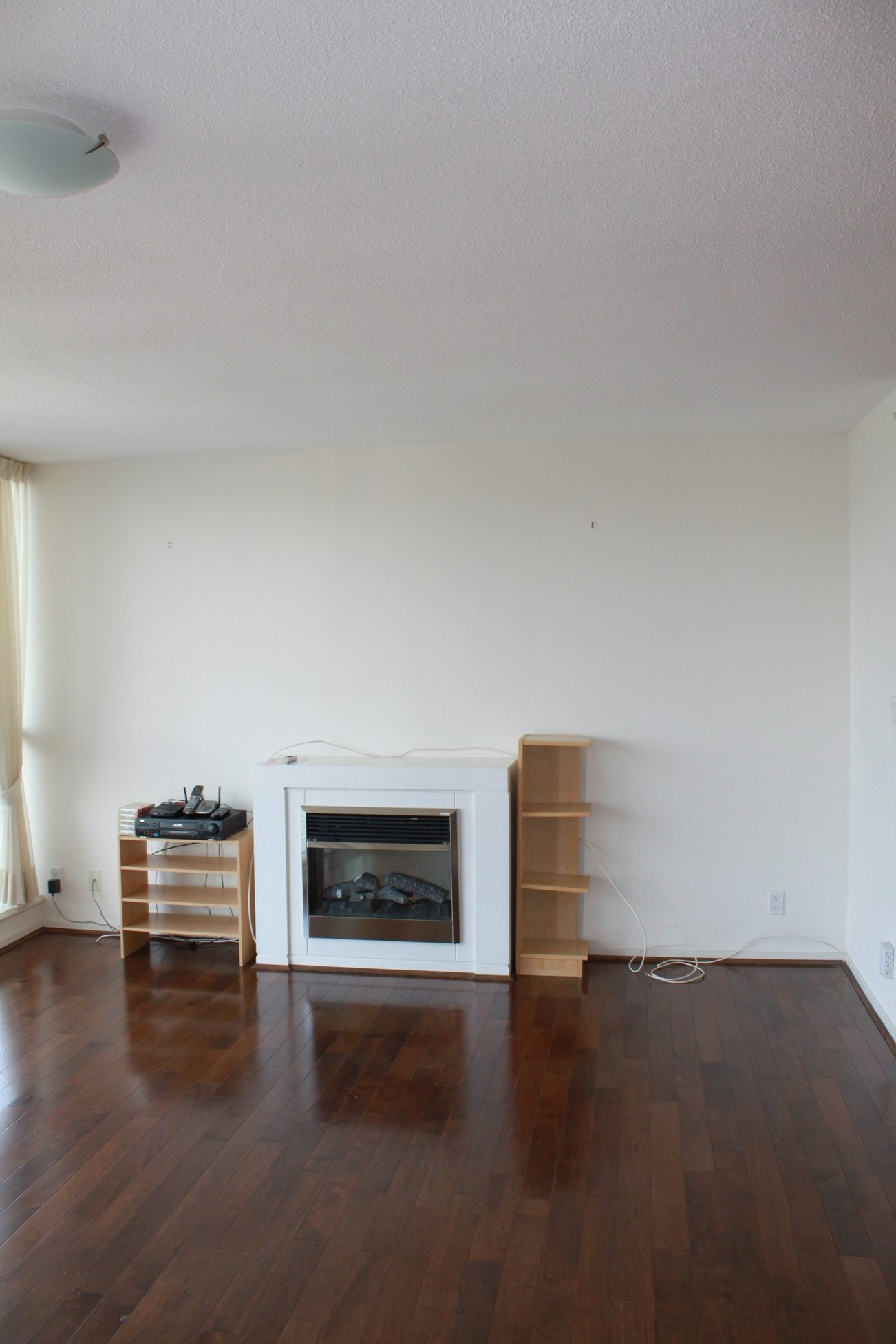 Bright living room with hardwood floors and a modern electric fireplace. - 2001 - 1199 Seymour, Vancouver Downtown