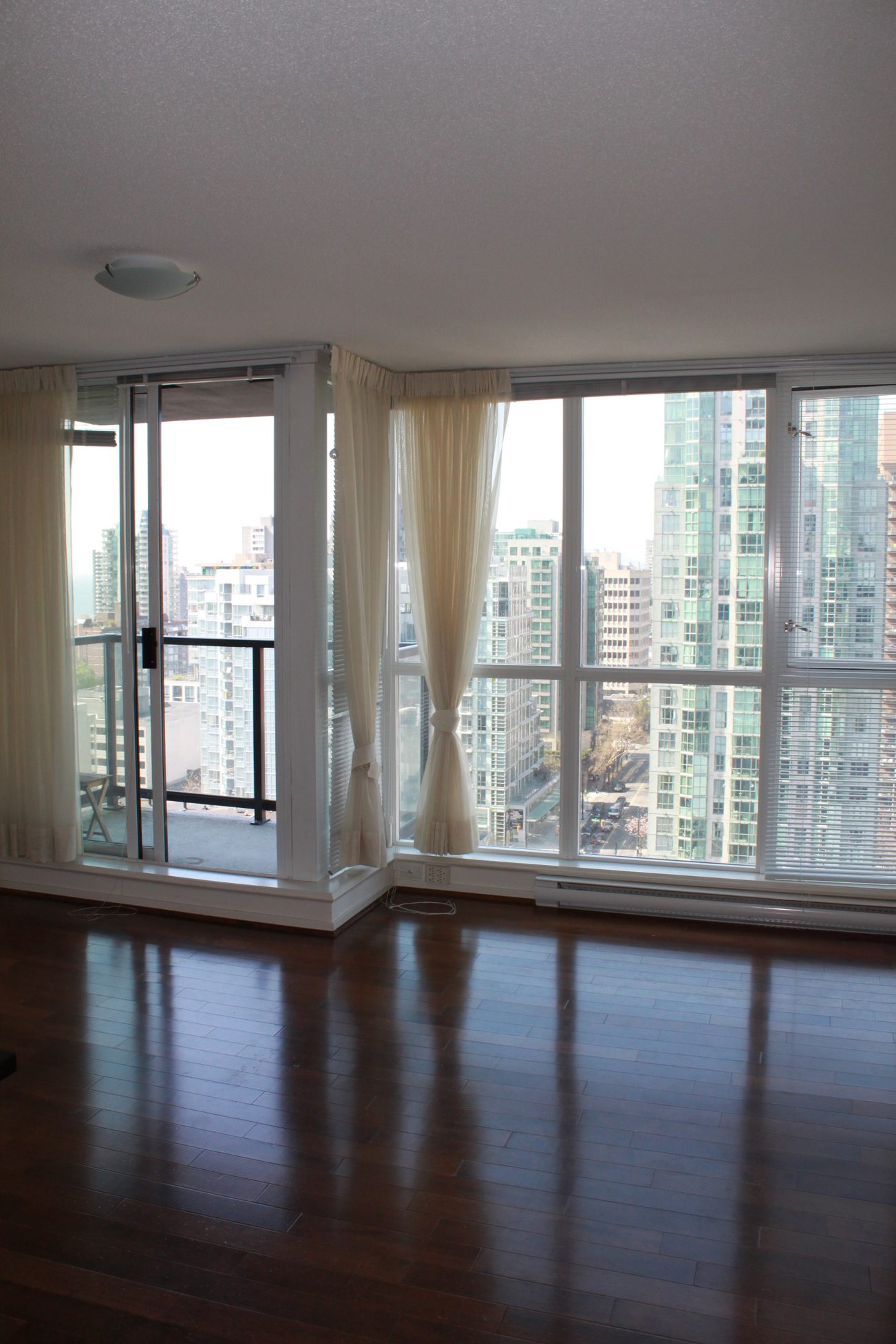 Bright living room with hardwood floors and a stunning city view. - 2001 - 1199 Seymour, Vancouver Downtown
