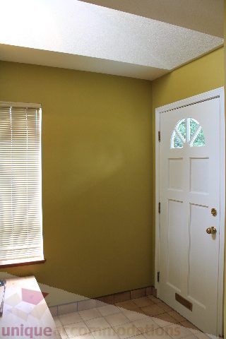 Bright kitchen with green walls, white cabinets, and tiled floor. - 2156 Cortell Ave, North Vancouver