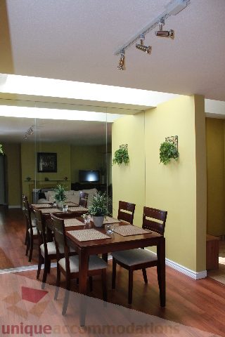 Furnished dining area with hardwood floors and a view of the living room. - 2156 Cortell Ave, North Vancouver