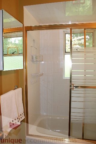 Bright bathroom with large shower and frosted glass window. - 2156 Cortell Ave, North Vancouver
