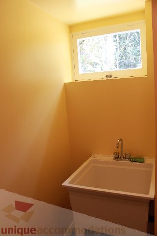 Small bathroom with white sink and window view. - 2156 Cortell Ave, North Vancouver