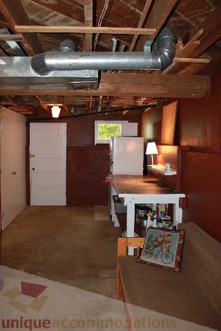 Den with exposed ceiling beams, countertop, and carpeted floor. - 2156 Cortell Ave, North Vancouver