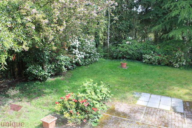 Furnished garden with lush greenery and blooming flowers. - 2156 Cortell Ave, North Vancouver