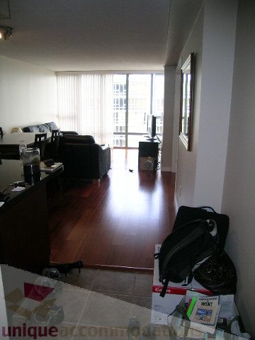 Bright living room with hardwood floors, city view, and modern furnishings. - 2507 - 950 Cambie Street, Vancouver Downtown