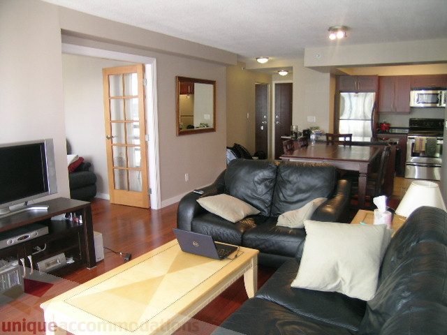 Furnished living room with hardwood floors, modern decor, and a cozy ambiance. - 2507 - 950 Cambie Street, Vancouver Downtown