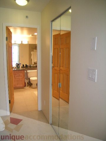 Furnished bathroom with wooden cabinets and a large mirror. - 2507 - 950 Cambie Street, Vancouver Downtown