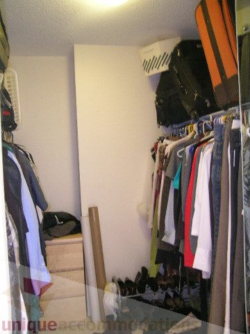 Closet with neatly organized clothes and hanging bags, showcasing a well-maintained living space. - 2507 - 950 Cambie Street, Vancouver Downtown