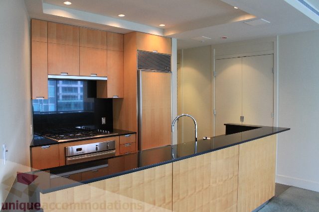 Modern kitchen with sleek countertops and city view. - 2205 - 1077 West Cordova, Vancouver Downtown