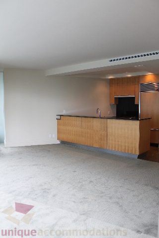 Modern kitchen with sleek countertops and wooden cabinets, perfect for a cozy downtown condo. - 2205 - 1077 West Cordova, Vancouver Downtown