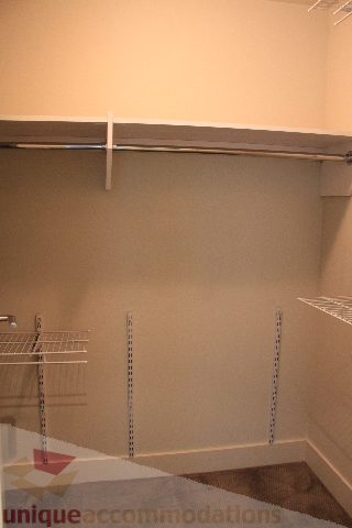 Spacious walk-in closet with built-in shelves and a sliding door. - 2205 - 1077 West Cordova, Vancouver Downtown