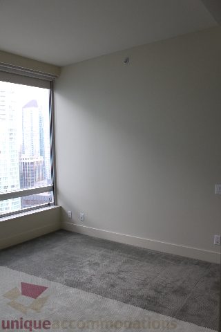 Spacious bedroom with a large window offering a stunning city view. - 2205 - 1077 West Cordova, Vancouver Downtown