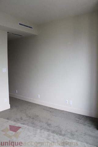 Spacious bedroom with neutral walls and carpeted floor, ready for furnishings. - 2205 - 1077 West Cordova, Vancouver Downtown