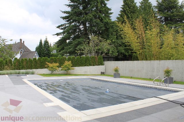 Spacious patio with concrete flooring and greenery. - 6012 Newton Wynd, Vancouver West Side
