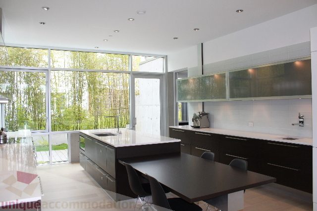 Bright kitchen with modern design, large windows, and city view. - 6012 Newton Wynd, Vancouver West Side