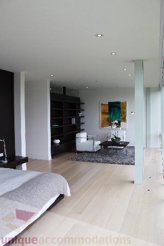 Spacious bedroom with hardwood floors and modern furniture. - 6012 Newton Wynd, Vancouver West Side