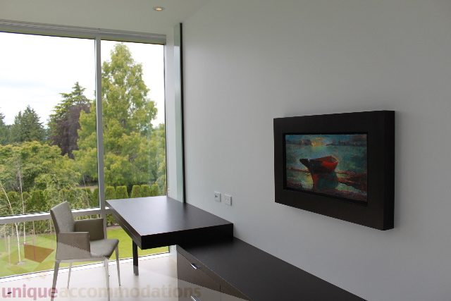 Bright living room with modern decor, large windows, and city view. - 6012 Newton Wynd, Vancouver West Side