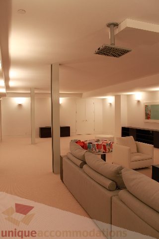 Spacious living room with modern furnishings and recessed lighting. - 6012 Newton Wynd, Vancouver West Side