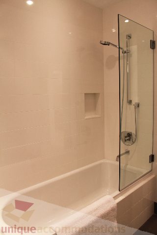 Bathroom with glass shower and bathtub, modern design. - 6012 Newton Wynd, Vancouver West Side