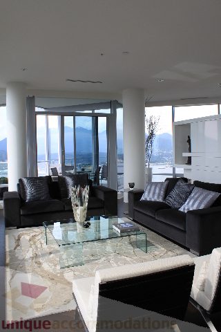 Bright living room with modern furniture, glass coffee table, and city view. - 6002 - 1128 West Georgia, Vancouver Downtown