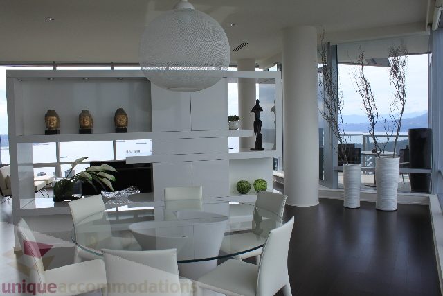 Bright living room with modern furniture, city view, and large windows. - 6002 - 1128 West Georgia, Vancouver Downtown