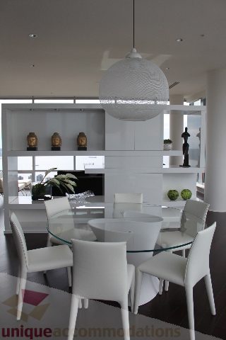 Bright dining area with white furniture, glass table, and modern decor. - 6002 - 1128 West Georgia, Vancouver Downtown