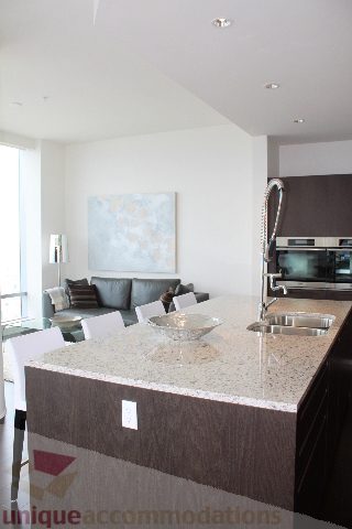 Bright kitchen with granite countertops and modern appliances, featuring a city view. - 6002 - 1128 West Georgia, Vancouver Downtown