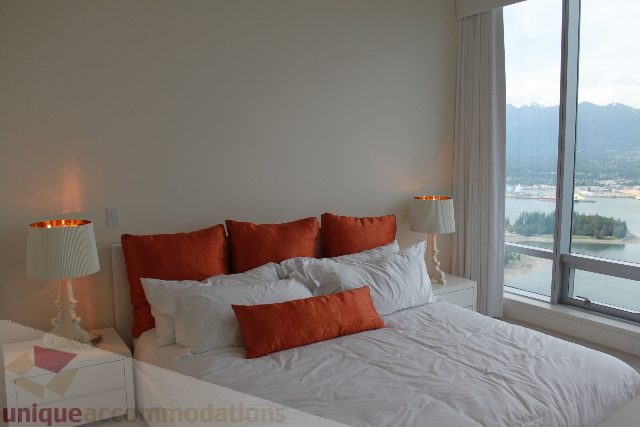 Furnished 2-bedroom condo with city view and orange accents. - 6002 - 1128 West Georgia, Vancouver Downtown