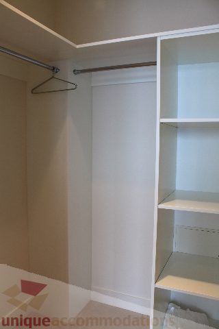 Furnished closet with hanging rod and shelves. - 6002 - 1128 West Georgia, Vancouver Downtown