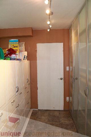Bathroom with orange walls, white door, and glass shower. - 2730 Ailsa Crescent, North Vancouver