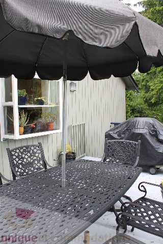 Furnished patio with outdoor furniture and umbrella, perfect for relaxing. - 2730 Ailsa Crescent, North Vancouver