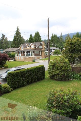 Furnished 4-bedroom house with a well-maintained lawn and a view of the surrounding trees. - 2730 Ailsa Crescent, North Vancouver