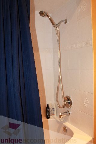 Bathroom with blue shower curtain and modern fixtures. - 2730 Ailsa Crescent, North Vancouver