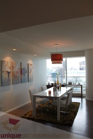 Furnished dining area with modern decor, city view, and hardwood floors. - 3304 - 1011 West Cordova, Vancouver Downtown