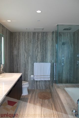 Furnished bathroom with marble countertops, hardwood floors, and a glass shower enclosure. - 3304 - 1011 West Cordova, Vancouver Downtown
