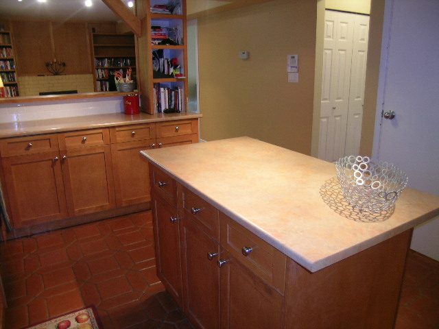 Bright kitchen with wooden cabinets and terracotta tile flooring. - 5753 Westport Road, West Vancouver