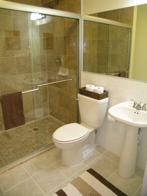 Bathroom with walk-in shower, white fixtures, and beige tile. - 5753 Westport Road, West Vancouver