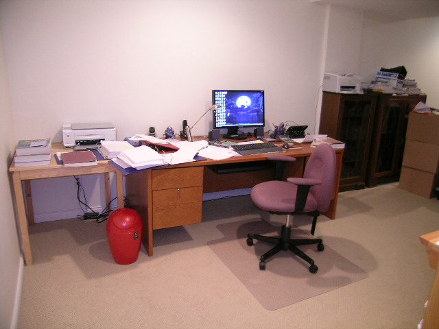 Home office with wooden desk, computer, and office chair. - 5753 Westport Road, West Vancouver