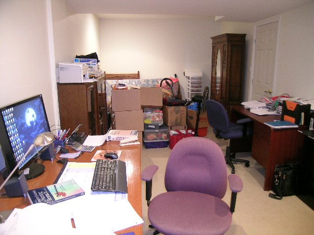 Cluttered home office with purple chairs and a computer desk. - 5753 Westport Road, West Vancouver