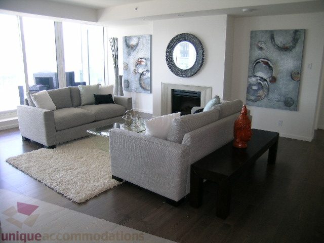 Furnished living room with hardwood floors, modern decor, and a city view. - 3306 - 1011 West Cordova Street, Vancouver Downtown
