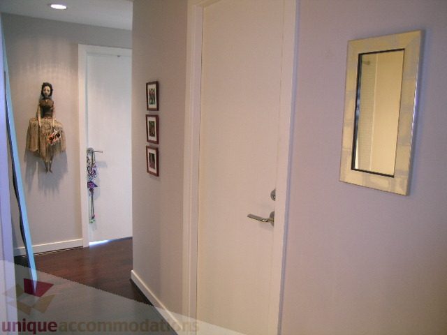 Foyer with white walls, wooden floor, and decorative doll. - 707 - 638 Beach Crescent, Vancouver Downtown