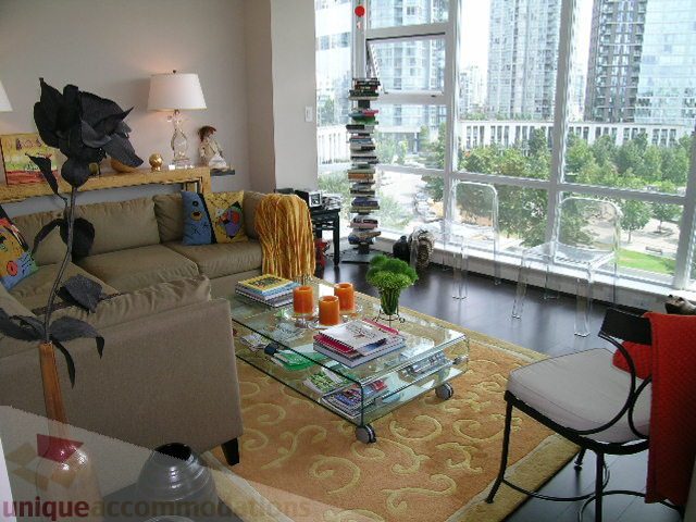 Furnished living room with city view, glass coffee table, and patterned rug. - 707 - 638 Beach Crescent, Vancouver Downtown