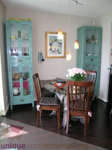 Furnished dining area with teal cabinets and wooden chairs. - 707 - 638 Beach Crescent, Vancouver Downtown