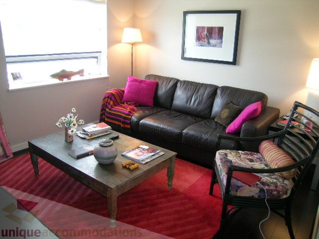 Furnished living room with leather couch, red rug, and decorative pillows. - 707 - 638 Beach Crescent, Vancouver Downtown